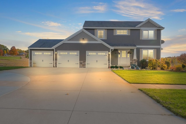 craftsman-style house featuring a yard and a garage