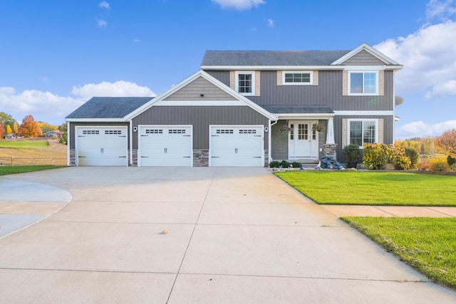 craftsman house with a garage and a front lawn