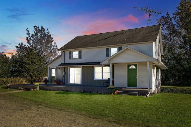 view of front of home featuring a lawn and covered porch