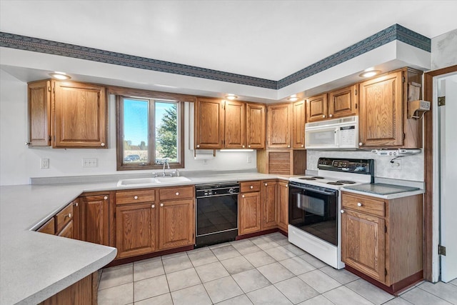 kitchen with sink, light tile patterned floors, and white appliances