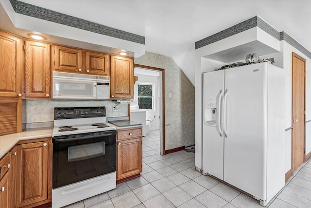 kitchen with light tile patterned floors and white appliances