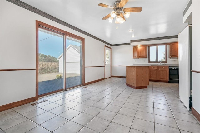 kitchen featuring sink, crown molding, ceiling fan, light tile patterned floors, and black dishwasher