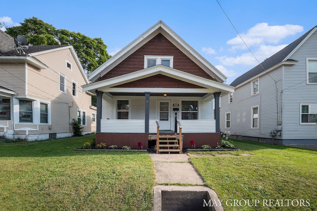 bungalow-style house featuring a porch and a front lawn