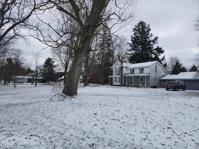 yard covered in snow with a garage