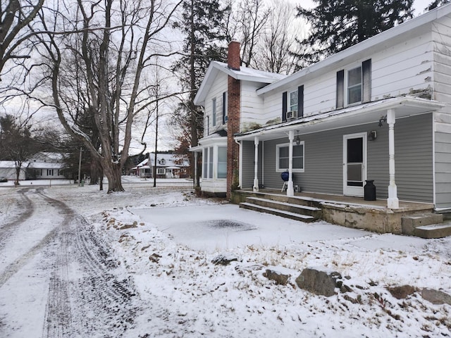 view of snow covered exterior with covered porch