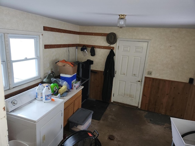 laundry room with cabinets, washer / clothes dryer, and wooden walls