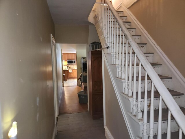 staircase with hardwood / wood-style floors