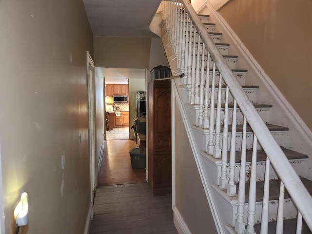 stairs with hardwood / wood-style floors