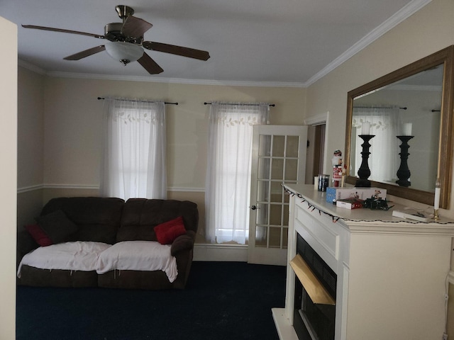 living room with ceiling fan and ornamental molding