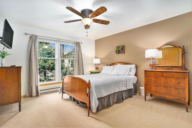 carpeted bedroom with ceiling fan and a baseboard heating unit