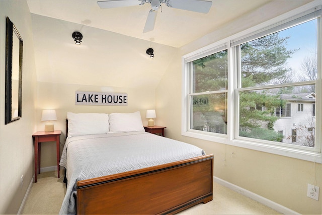 carpeted bedroom featuring ceiling fan and vaulted ceiling