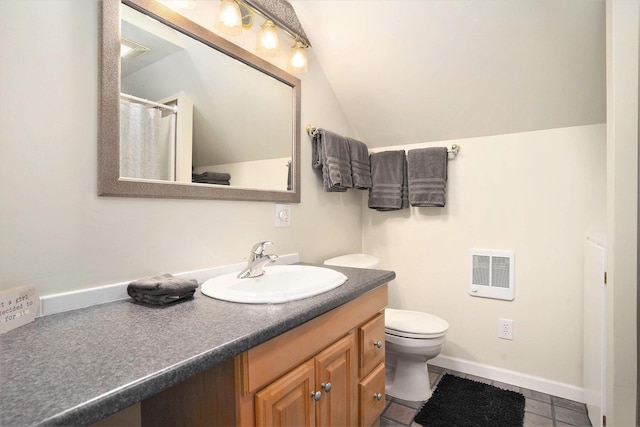 bathroom with tile patterned floors, vanity, lofted ceiling, and toilet