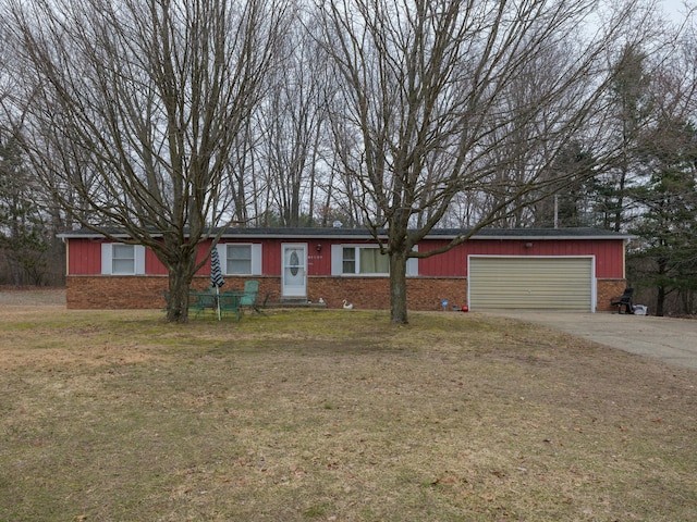 ranch-style home with a garage, concrete driveway, brick siding, and a front lawn