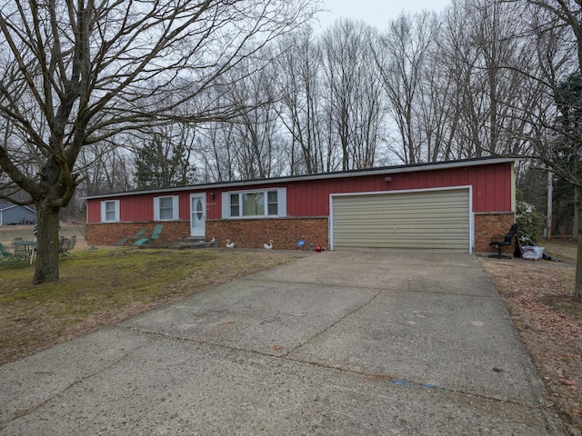 ranch-style home featuring a garage, driveway, and brick siding