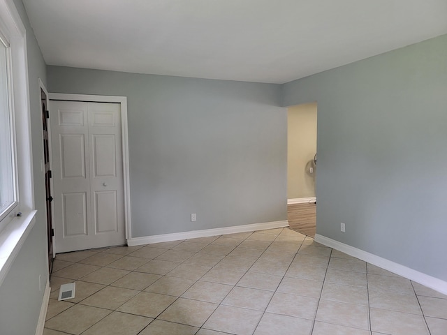 unfurnished room with light tile patterned floors