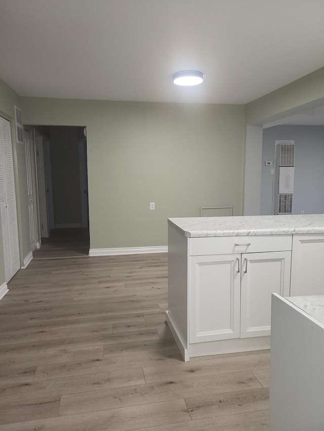 kitchen featuring light hardwood / wood-style floors and white cabinetry