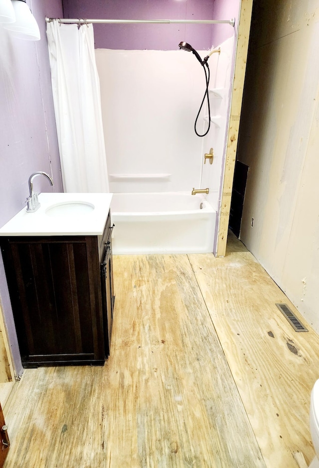 bathroom with shower / bath combo with shower curtain, vanity, and hardwood / wood-style flooring