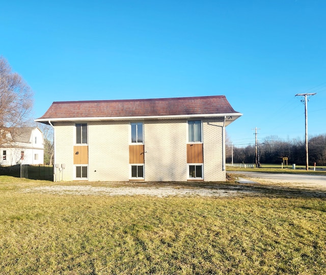 rear view of property with a yard