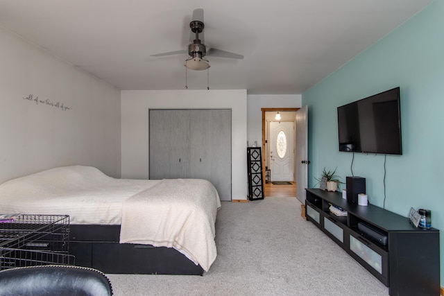 bedroom featuring ceiling fan, a closet, and carpet