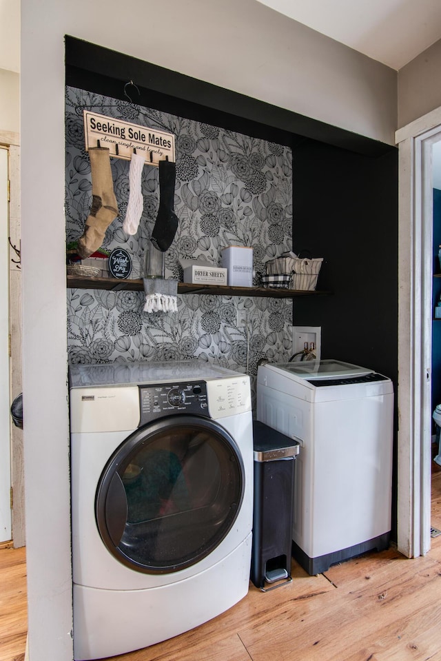 laundry room with wood-type flooring and washer and clothes dryer