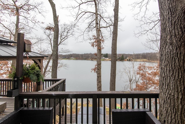 wooden terrace featuring a water view