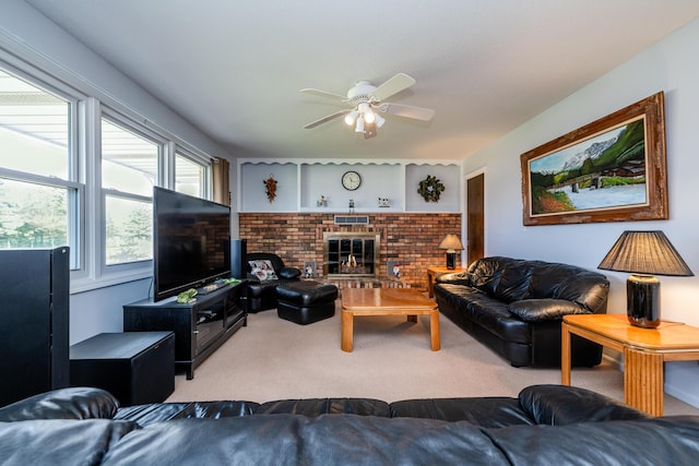 living room with ceiling fan, carpet floors, a fireplace, and brick wall