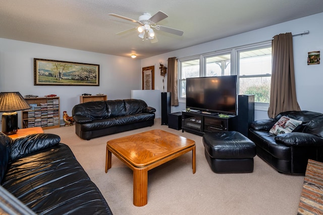 carpeted living room with ceiling fan