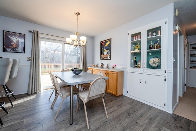 dining space featuring a chandelier and dark hardwood / wood-style floors