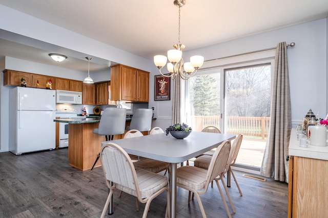 dining room featuring dark hardwood / wood-style flooring and a chandelier