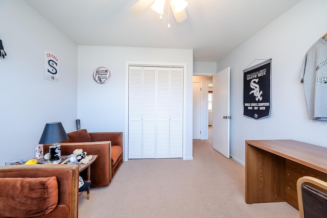 sitting room with light colored carpet and ceiling fan