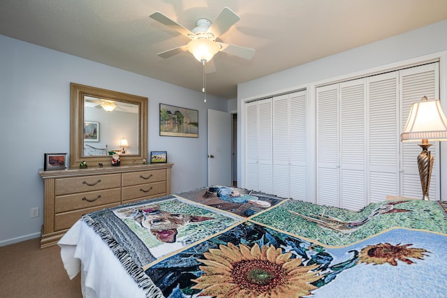 bedroom featuring carpet flooring, two closets, and ceiling fan