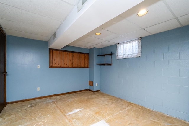 basement with a paneled ceiling