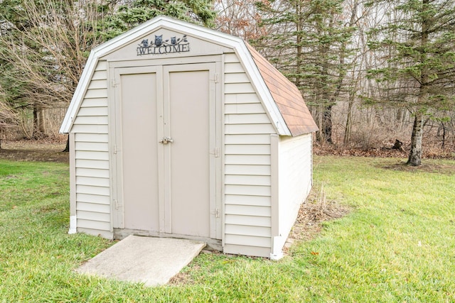 view of outbuilding featuring a yard