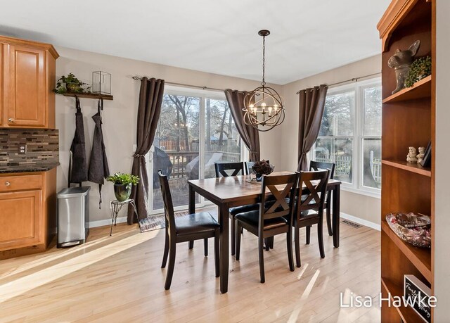 dining room with a chandelier and light hardwood / wood-style flooring