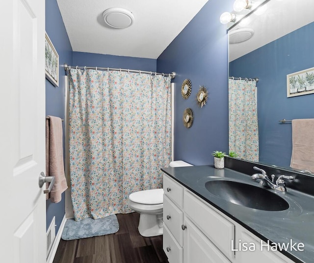 bathroom with hardwood / wood-style floors, vanity, and toilet