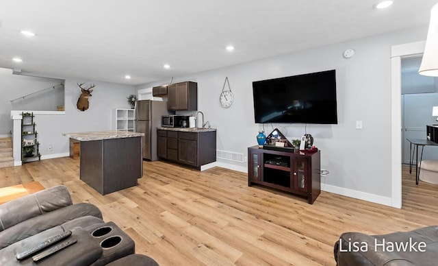 living room featuring light hardwood / wood-style flooring and sink