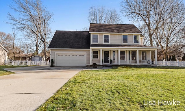 view of front of house featuring covered porch, a garage, and a front yard