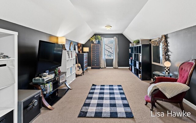 interior space featuring carpet and vaulted ceiling