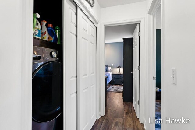 clothes washing area with washer / clothes dryer and dark hardwood / wood-style flooring