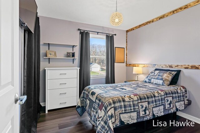 bedroom with dark wood-type flooring