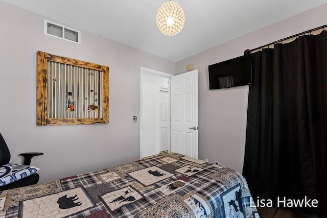 bedroom featuring a notable chandelier