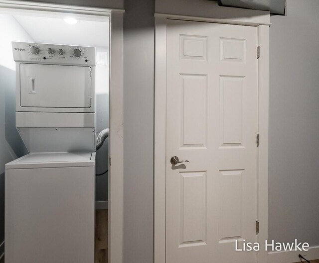 clothes washing area with stacked washer / dryer