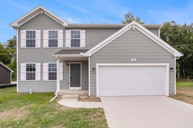 view of front of property featuring a garage and a front lawn