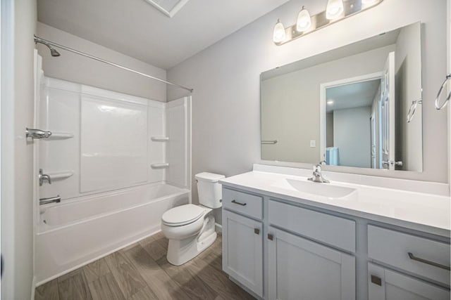 full bathroom featuring wood-type flooring, toilet, vanity, and  shower combination