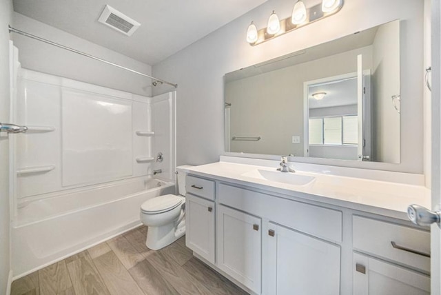 full bathroom featuring vanity, toilet, hardwood / wood-style floors, and shower / bathing tub combination