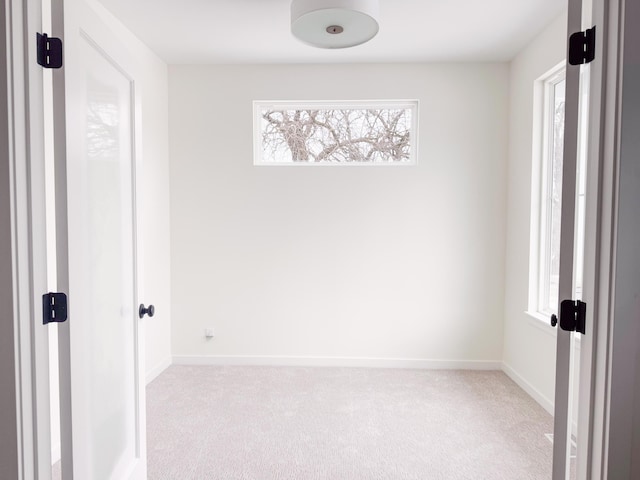 unfurnished room with light carpet and a wealth of natural light