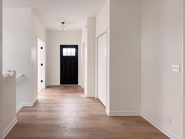 foyer entrance with light hardwood / wood-style floors