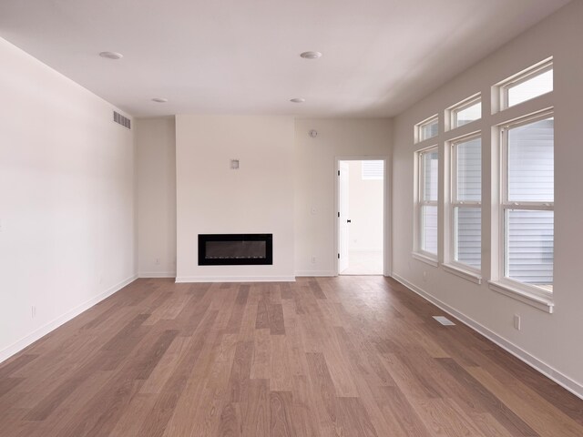 unfurnished living room featuring wood-type flooring