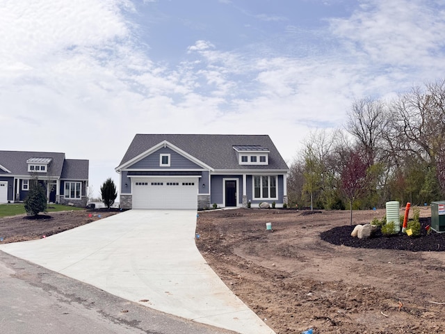 craftsman-style home featuring driveway, an attached garage, and stone siding