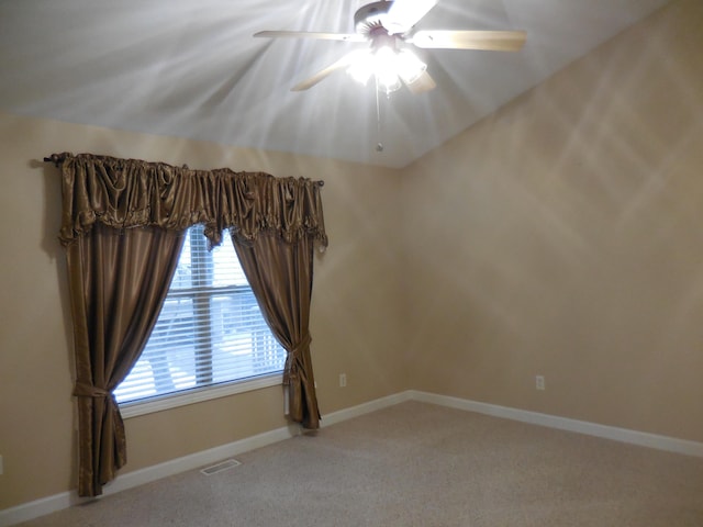 carpeted empty room featuring ceiling fan